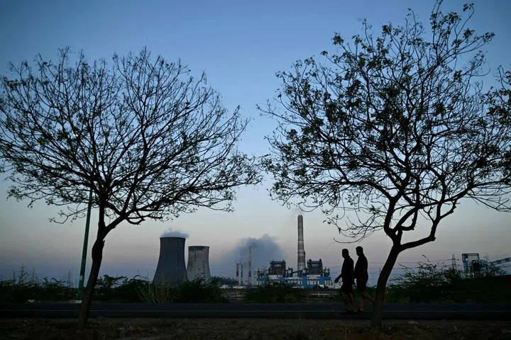 People walk near the Tuticorin Thermal Power Station at Thoothukudi in India's Tamil Nadu state on September 8, 2026. Tamil Nadu is among the state’s seeking more power allocations.