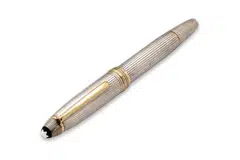 The writing instrument features a sterling silver cap and body accented by yellow-toned metal highlights, and an 18K gold nib.