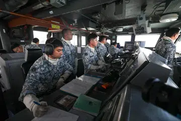 The crew of the Mine Countermeasure vessel (MCMV) RSS Punggol conducting leadthrough operations of a minefield transit on the bridge of the vessel during a simulation exercise on June 23, 2026.