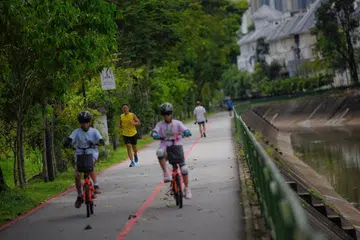 People cycle along the park connector running along the Ulu Pandan canal.