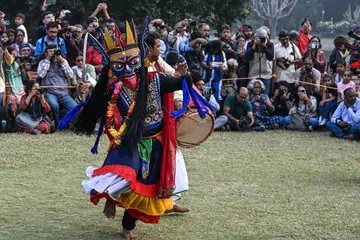An artiste performs Gomira, a traditional masked dance, as part of the World Heritage Week celebration at the Victoria Memorial in Kolkata on Nov 25.