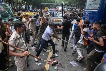 Police personnel baton-charge to disperse activists and supporters of the Cockroach Janta Party (CJP) during the protest