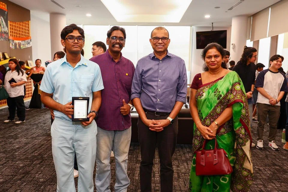 MELVIN ELLIOT (far left) with parents and GOH Dr Janil (blue shirt)
