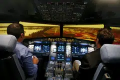 Preparing for landing in an A320 flight simulator.
