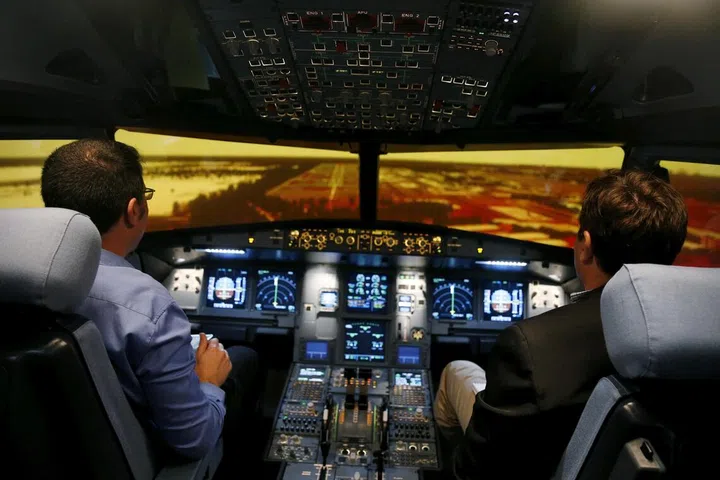 Preparing for landing in an A320 flight simulator.