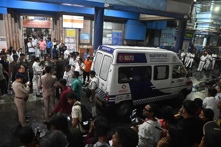 An ambulance carrying Durga Puja Pandal stampede victims stops in front of the emergency building of Calcutta Medical College and Hospitalas relatives of Durga Puja Pandal stampede victims mourn in Kolkata on October 16, 2026.