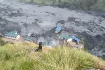 AFPTV video taken on October 11, 2026 shows flood water destroying buildings along the Budhi Gandaki river, following a flash flood caused by a dry landslide, at Sallari Chumnubri in Nepal's Gorkha district on October 11, 2026.