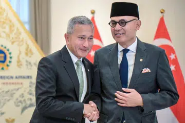 Indonesian Foreign Minister Arrmanatha Nasir (R) and Singaporean Foreign Minister Vivian Balakrishnan (L) shake hands during a photo session ahead of their bilateral meeting at the Ministry of Foreign Affairs in Jakarta on October 27, 2026.