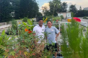 Mr Biju George (left) and Mr Edmund Kuek converted empty carpark visitor lots into a community garden.