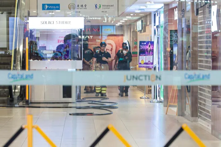 SCDF and SPF officers seen in a sealed off area inside Junction 8