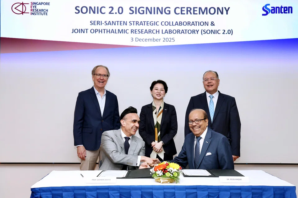 Singapore Eye Research Institute (SERI) executive director Jodhbir Mehta (seated, left) with Santen’s Ophthalmology Innovation Center head Reza Haque at the Singapore National Eye Centre (SNEC) on Dec 3, 2025.