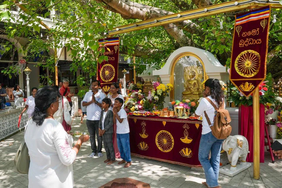 Devotees at the sacred Bodhi tree shrine at Sri Lankaramaya Temple on Vesak Day (May 31).