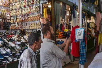 A customer makes a payment through the Unified Payments Interface (UPI) at a shop in Srinagar,  Jammu and Kashmir.