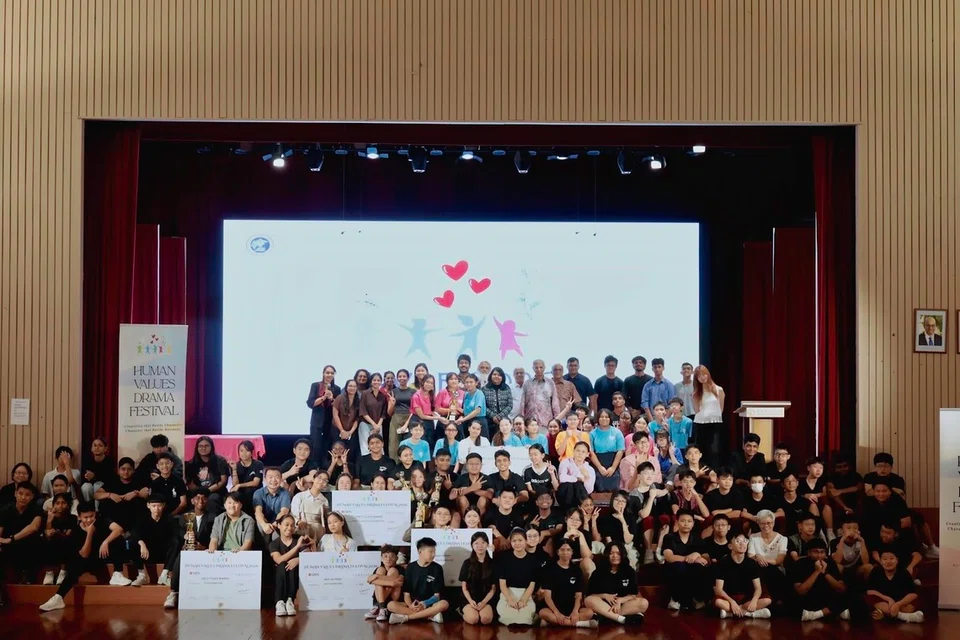 Judges, organisers, and participants from the four secondary schools gather on stage at the conclusion of the 2026 Human Values Drama Festival (HVDF) Finals