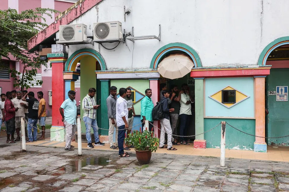 Migrant workers queueing to use the Kudai Canteen toilet in Chander Road.