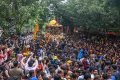 Devotees and members of the International Society for Krishna Consciousness (ISKCON) hold a rope attached to the chariot as they attend the Rath Yatra (chariot procession) of Lord Jagannath, organized by ISKCON in Mumbai, India,.