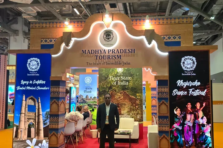 Dr Ilayaraja T in front of the Madhya Pradesh Tourism booth at ITB Asia 2026, held at Marina Bay Sands Expo and Convention.