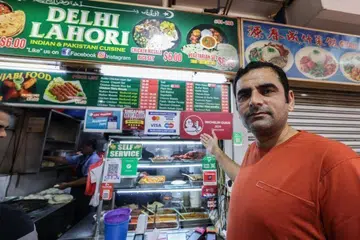 Mr Naseer Ahmed Khan at his Delhi Lahori stall in Tekka.