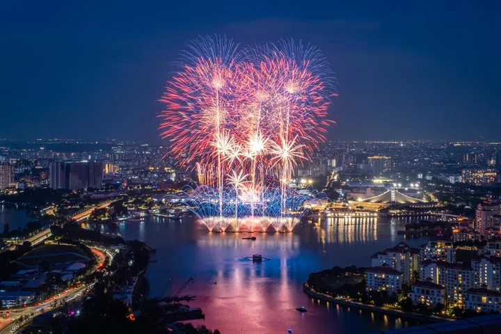Fireworks illuminate the evening sky over Kallang Basin during the National Day Parade 2026 at the National Stadium, as seen from Suntec City on Aug 9, 2026.