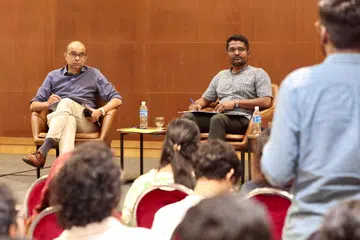 Chairman of OnePeople.sg Dr Janil Puthucheary (left) and Tamil Murasu Audience and Growth Editor and tabla! Editor Venga Subramaniam taking note of a youth’s question.