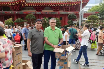 Mr Mukesh Metharam and Mr Naresh Vaswani at their distribution point on Oct 4.