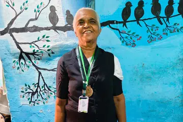 Mrs Thayammal dressed in court attire in front of her house in Tirunelveli, a city in the Indian state of Tamil Nadu.
