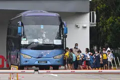 Children boarding a school bus at Punggol View Primary School.