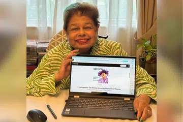 Mdm Zaibun Siraj with her audiobook.