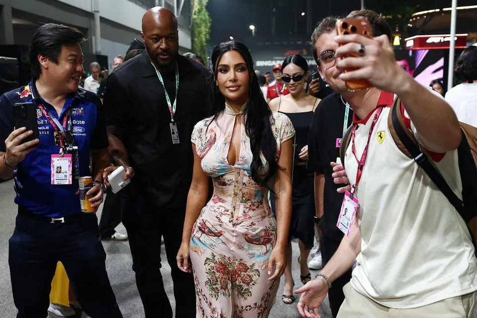 Formula One F1 - Singapore Grand Prix - Marina Bay Street Circuit, Singapore - October 11, 2026. Kim Kardashian poses for a picture during the race