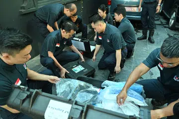 Singapore Police Force officers checking and inspecting their equipment before setting off from their base in Kathmandu, Nepal on Sept 5.