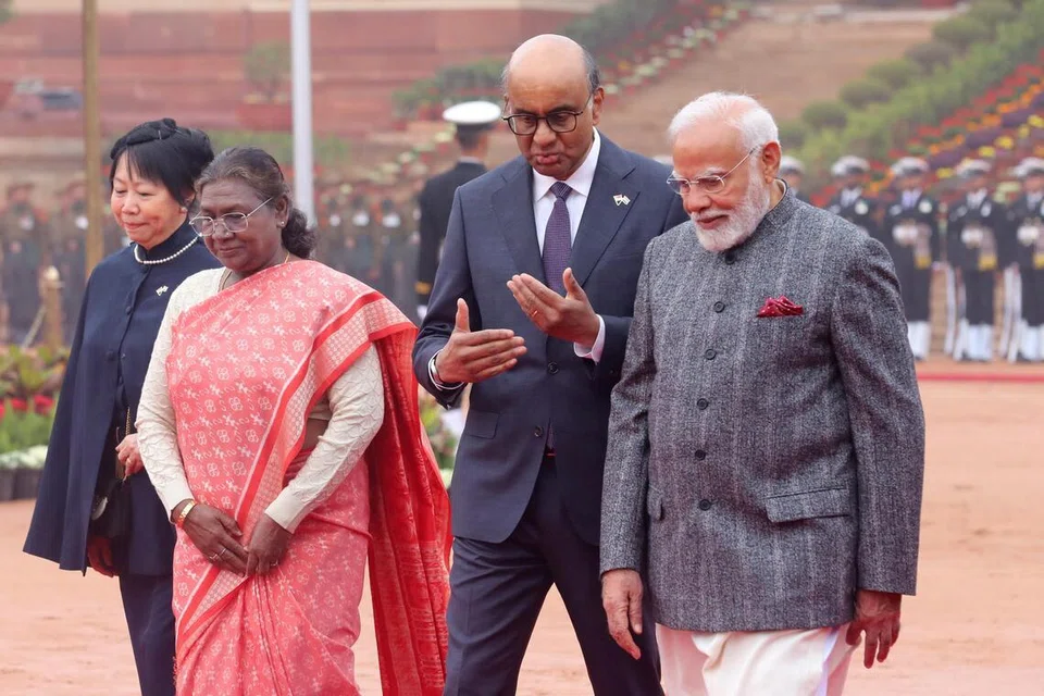 Mr Tharman speaking with Indian Prime Minister Narendra Modi as India’s President Droupadi Murmu and Mr Tharman’s wife Jane Ittogi walk alongside.