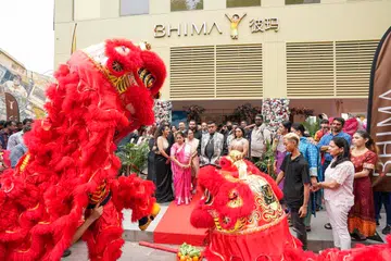 Invited guests watch lion dancers perform at the launch event of Bhima Jewellers’ first store in Little India, Singapore.