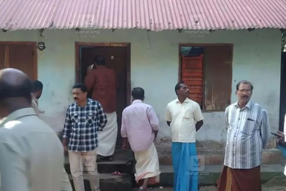 Neighbours outside the home in Thiruvananthapuram, Kerala, where the woman died after giving birth.