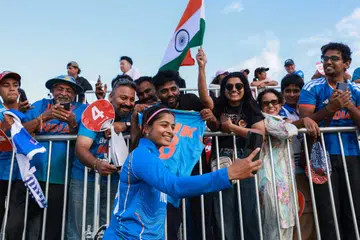 India's Shreyanka Patil poses with supporters after their victory in the women's gold medal cricket match between India and Sri Lanka during the 2026 Asian Games