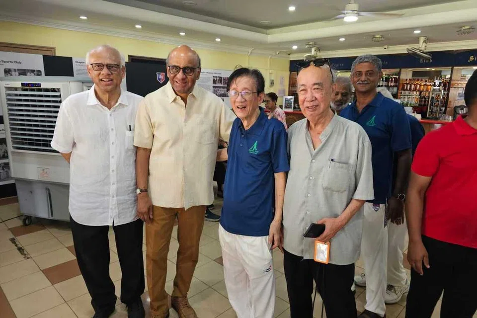 President Tharman Shanmugaratnam (centre) with SloMo 2026 chief organiser Wang Hoe Sang (left) and other players.