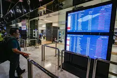 A stranded passenger looking at the departure board for the status of flights at Soekarno-Hatta International Airport on Sept 6.