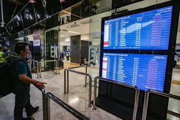A stranded passenger looking at the departure board for the status of flights at Soekarno-Hatta International Airport on Sept 6.