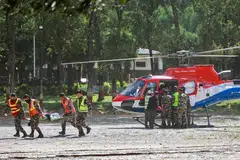 Army personnel carry a rescued resident at an army camp following flash floods, in Battar Bazar town of Nepal's Nuwakot district on August 28, 2026.