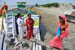 A medic measures the height of a pregnant woman at a mobile boat clinic in Mukalmua village of Assam's Nalbari district.