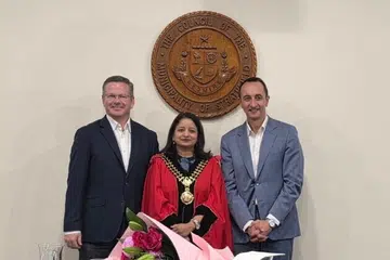 Sandy Reddy (centre) is a first generation migrant from India