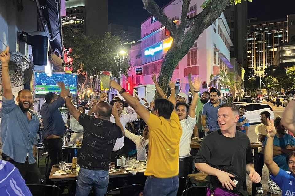 Fans at The Mask Restaurant and Bar in Circular Road celebrating after India beat New Zealand in the Cricket World Cup.