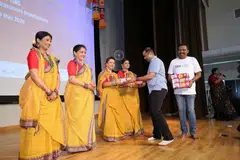 Mr Sanyam Joshi, First Secretary (Economic), High Commission of India, presenting boxes of mangoes to dancers from Bengali Sarbojonin Society Singapore.