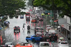 People crossing Geylang Road under the rain as seen from overhead bridge next to Haig Road Market & Food Centre on Sept 27, 2026.  Meanwhile, the temperature fell to a low of 20.7 deg C at Clementi Road.