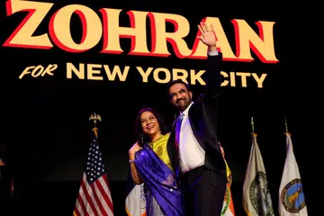 Democratic candidate for New York City mayor Zohran Mamdani waves next to his mother Mira Nair onstage after winning the 2025 New York City Mayoral race.