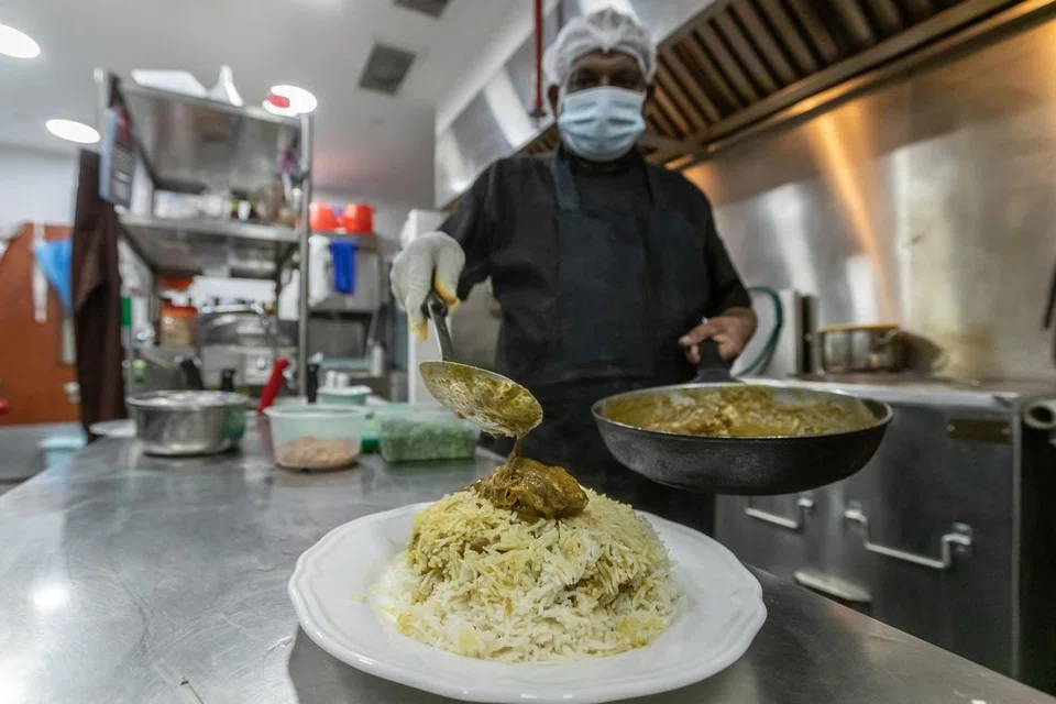 The chef at Bama’s Kitchen serving duck biryani.