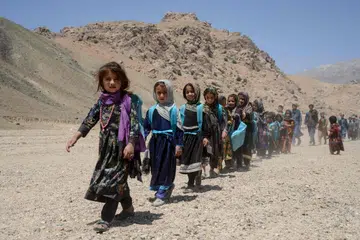 Afghan children leave after attending a primary school in Khvajeh Atis village in southern Afghanistan's Zabul province earlier in 2026.