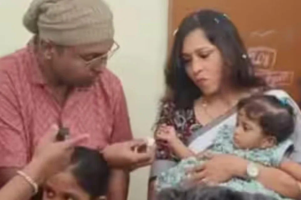 தத்தெடுத்த குழந்தையுடன் இமான்.