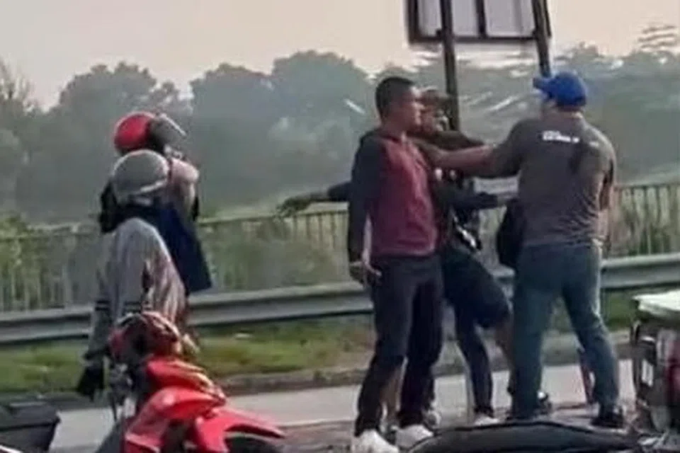 மோட்டார் சைக்கிள் ஓட்டியை காரில் வந்தவர்கள் முகத்திலும் வயிற்றிலும் குத்தியிருக்கின்றனர்.