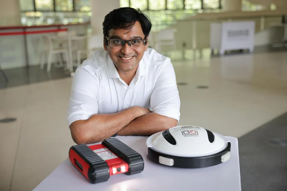சிங்கப்பூர் தொழில்நுட்ப, வடிவமைப்பு பல்கலைக்கழக (எஸ்யுடிடி) இணை பேராசிரியர் மோகன் ராஜேஷ் எலாரா பல்கலைக்கழகம் உருவாக்கிய ரோபோக்களுடன்: ஃபால்கன் (இடது)- கூரையை ஆய்வு செய்யும் இயந்திரம், நஜா, பாம்பு விரட்டி. 