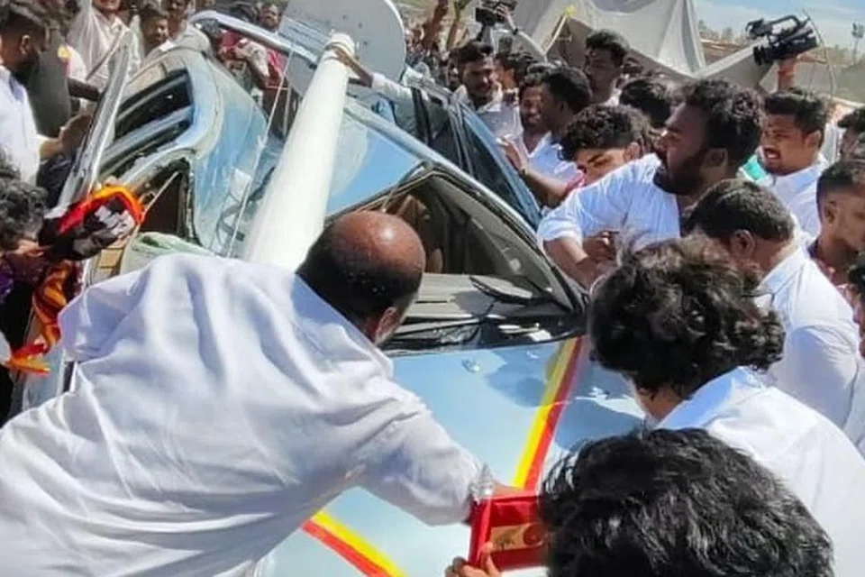 மாநாட்டுத் திடலில் 100 அடி கொடிக்கம்பம் விழுந்ததில் பலத்த சேதமடைந்த கார்.